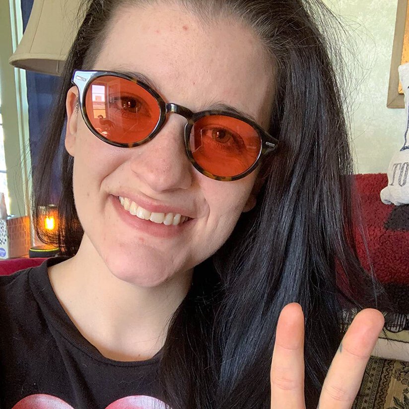 Amazon customer wearing Keaton TheraSpecs giving the peace sign