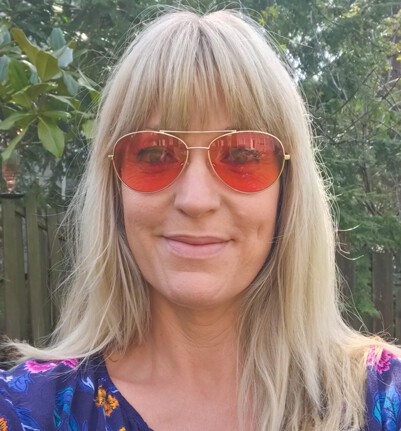 Barb Wearing indoor Pilot TheraSpecs glasses for migraine