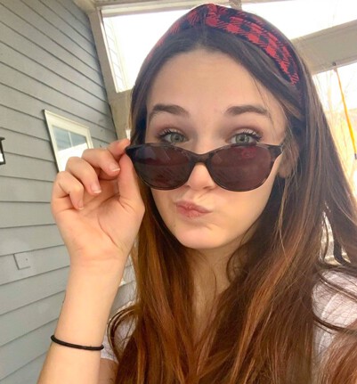 Faith wearing outdoor Audrey TheraSpecs for migraine relief