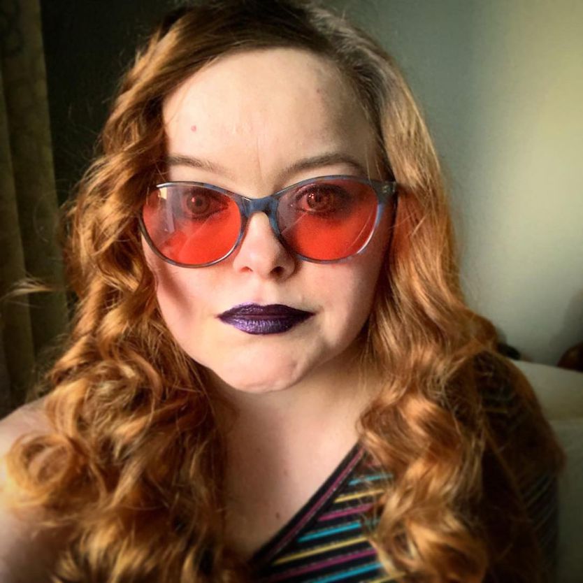 Jacqueline uses TheraSpecs to reduce her migraine attacks & light sensitivity Jacqueline wearing her Audrey blue indoor TheraSpecs