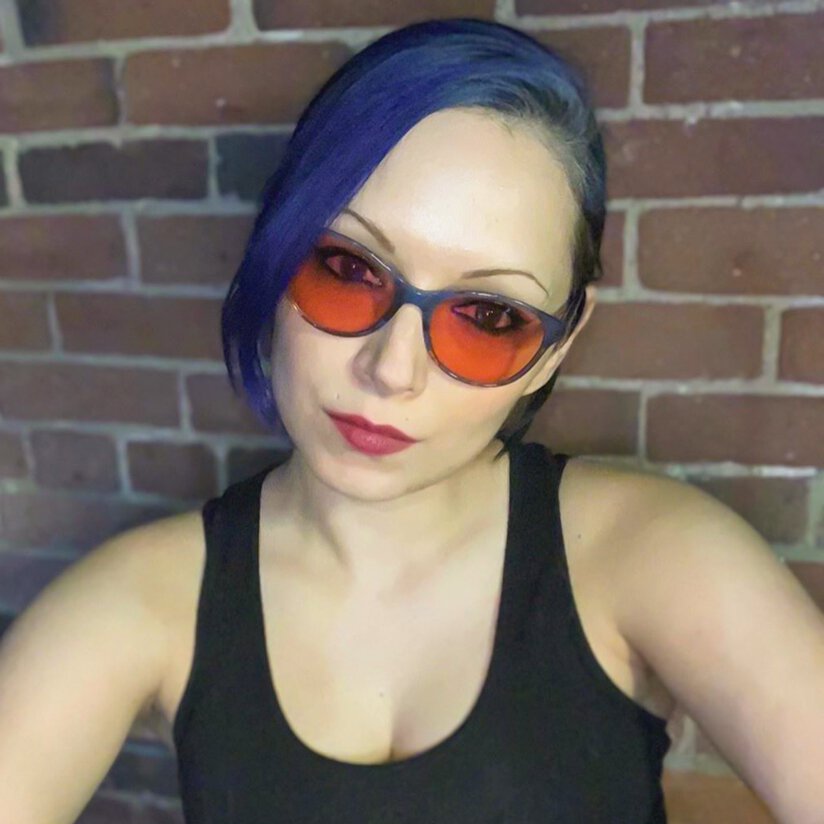 Another photo of Jess wearing her Audrey TheraSpecs glasses Woman wearing indoor TheraSpecs