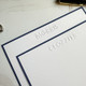Your Logo Embossed on Flat Cards 4.5 x 6.25 at StationeryXpress.com - Shown with White Paper and Navy Blue Border Close Up