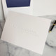 Your Logo Embossed on Folded Notes Example - 4.5" x 6.25" - Optional Border - StationeryXpress.com
(Embossed with no color and no ink. Optional Navy Envelope Liner in back, pen not included)
