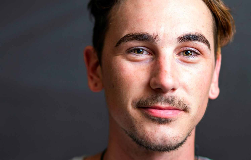 Light facial hair growth on the jawline and chin, indicating readiness for a first shave