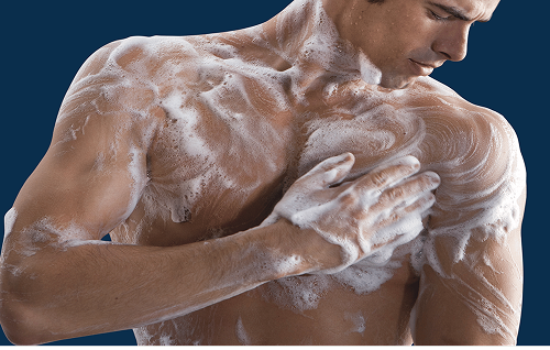 Preparing chest hair for shaving by applying shaving cream evenly