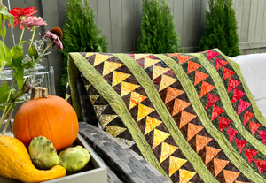Fall flying geese quilt with a pumpkin