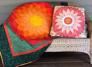 Finished Dahlia quilt and pillow on a bench