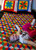Finished tumbling block quilt with toddler playing