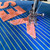 Showing stitching the letters onto a quilt