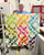 Jacob's Ladder finished quilt being held by a woman