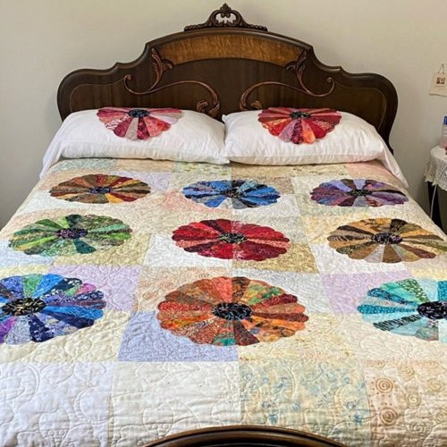 Dresden plate quilt on a bed