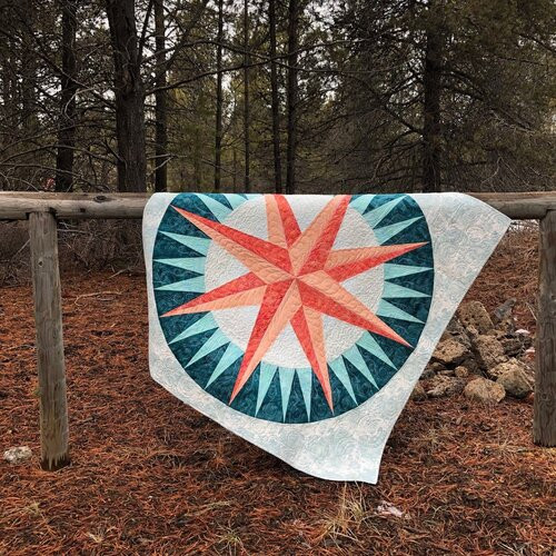 Mariners Compass quilt over a fence post