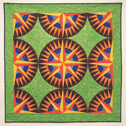 Finished Mini Mariners Compass quilt with green background