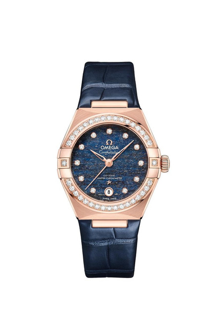 OMEGA Constellation co-axial Master Chronometer 29 mm watch, featuring a blue textured dial with diamond hour markers, a diamond-set bezel, and a navy leather strap.