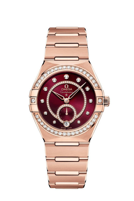 Omega Constellation co-axial Master Chronometer Small Seconds 34 mm watch, luxurious rose gold bracelet and case with diamond accents and a deep red dial with diamond hour markers.