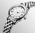 Longines Flagship [L4.274.4.21.6] watch, close-up of a luxury stainless steel wristwatch with a silver dial, Roman numeral hour markers, a date window at 4:30, and three hands for hours, minutes, and seconds.