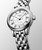 Longines Flagship watch, silver dial with Roman numerals, date display, and stainless steel bracelet.