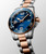 LONGINES HYDROCONQUEST watch, close-up view of a sophisticated diver's wristwatch with a blue dial, gold and stainless steel two-tone bracelet, and a rotating bezel.