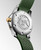 Longines HydroConquest, watch back with brand logo embossed, stainless steel case with gold crown, and green rubber strap with engraved details.