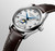 Longines The Longines Master Collection [L2.409.4.78.3], luxury men's watch with silver textured dial, moon phase and date subdials, blue hands, and brown leather strap.