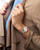 LONGINES CONQUEST CLASSIC [L2.386.3.72.7], wristwatch on woman's wrist with a silver and gold band and a white dial, in a chic fashion style.