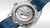 Omega Seamaster Aqua Terra 150M Co-Axial Master Chronometer GMT Worldtimer 43 mm watch, view of the intricate mechanical movement through the transparent case back with blue leather strap.
