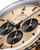 OMEGA Speedmaster Moonwatch Professional co-axial Master Chronometer Chronograph 42 mm, close-up view of the gold watch face with black subdials and black hour markers.