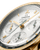 Omega Speedmaster 38 Co-Axial Chronometer Chronograph 38 mm, close-up of the luxury watch with a white dial, gold accents, and multiple chronograph subdials.
