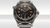 OMEGA Seamaster Diver 300M co-axial Master Chronometer 42 mm, detailed close-up of the black dial with luminescent hour markers and hands, and a stainless steel mesh bracelet.