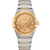 OMEGA Constellation Co-Axial Master Chronometer 39 mm watch with a gold dial and diamond hour markers, stainless steel and gold bracelet, and a date display at 6 o'clock.