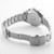 Roamer Watch, stainless steel wristwatch with a silver band and a round case, featuring a transparent back showing the watch's internal mechanism and branding details.
