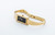 Roamer Watch, gold-colored rectangular wristwatch with a black dial and a diamond marker at 12 o'clock, featuring a matching gold bracelet