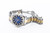 Roamer Watch, luxury men's wristwatch with a stainless steel and gold band, blue dial, rotating bezel, and date display.