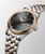 LONGINES Elegance Flagship Heritage [L4.984.3.77.7], a luxurious men's wristwatch with a black dial, rose gold bezel, and two-tone stainless steel bracelet.
