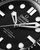 OMEGA Seamaster Diver 300M, close-up of the watch face showing the black textured dial, luminous hour markers, and the detailed hands.