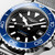 LONGINES Longines HydroConquest watch, detailed image of the black dial with white hour markers, blue bezel, and stainless steel bracelet.