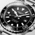 Longines HydroConquest [L3.788.4.56.6], close-up view of the black dial with luminous markers and hands, date display at the 3 o'clock position, stainless steel case and bracelet, professional diving watch with water resistance