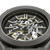 CERRUTI 1881 WATCH, close-up of a stylish men's automatic skeleton wristwatch with visible movement, black and silver dial, luminous hands and markers, and stainless steel case.