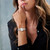 CERRUTI 1881 WATCH [CIWLG0012204], a stylish ladies' wristwatch with a silver and rose gold tone, round face, Roman numerals, and a bejeweled bezel, worn on a woman's wrist.