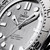 Omega Seamaster Diver 300M 42 mm, close-up image of a luxury stainless steel diving watch with a brushed silver dial, luminous hands and markers, and detailed bezel design.