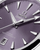 Omega Seamaster 38 mm, close-up of the purple dial watch with silver hour markers and hands, featuring the date window at 6 o'clock and the Omega logo.