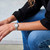CERRUTI 1881 WATCH [CIWLG0012202], a stylish silver wristwatch with a round face, Roman numeral markers, and a diamond-studded bezel, worn on a woman's wrist.