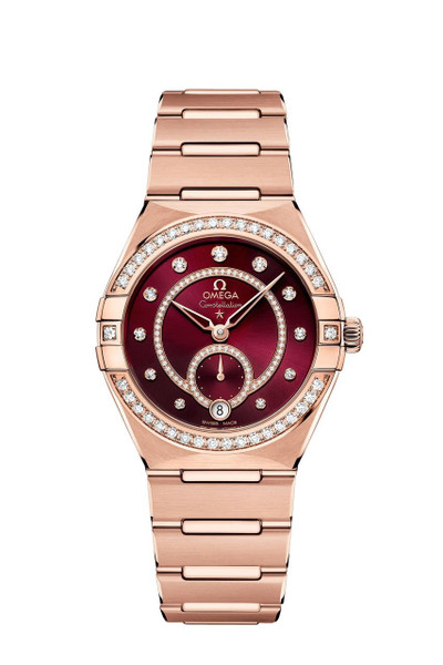 Omega Constellation co-axial Master Chronometer Small Seconds 34 mm watch, luxurious rose gold bracelet and case with diamond accents and a deep red dial with diamond hour markers.