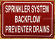 SPRINKLER SYSTEM BACKFLOW PREVENTER DRAINS COMPLIANCE SIGN