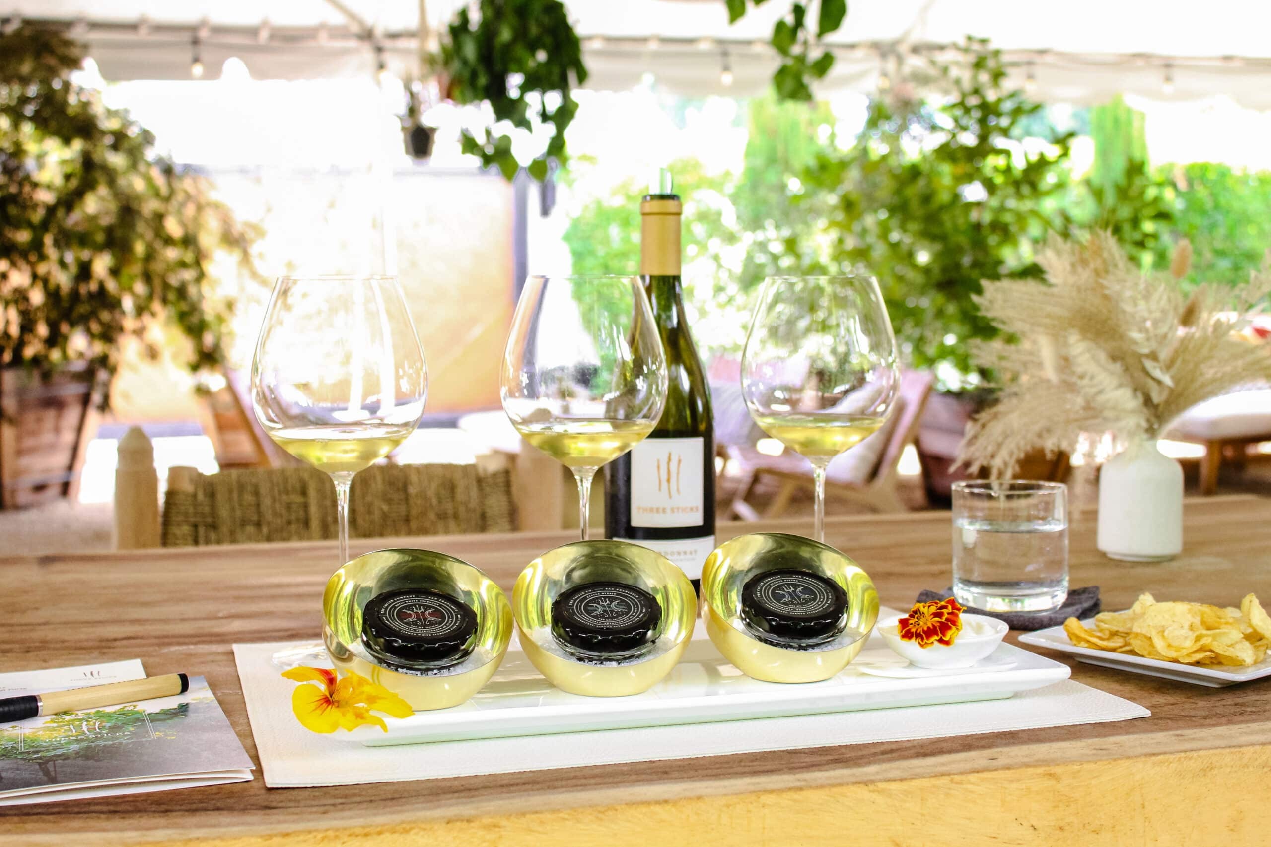 table with white wine glasses and caviar
