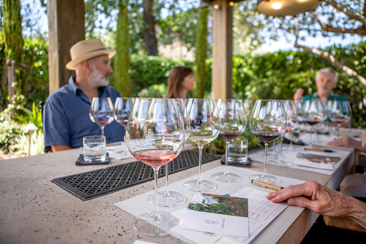 People around a table served with several glasses of wine