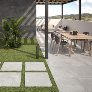 Slater Grey Outdoor Tile styled on a modern patio with garden furniture and planters. Slater Grey Outdoor Tile styled on a modern patio with garden furniture and planters.