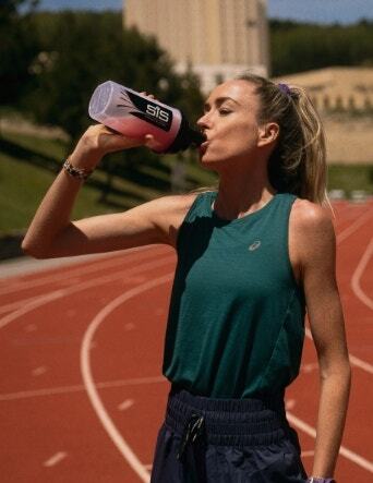 Athlete drinking from SiS bottle