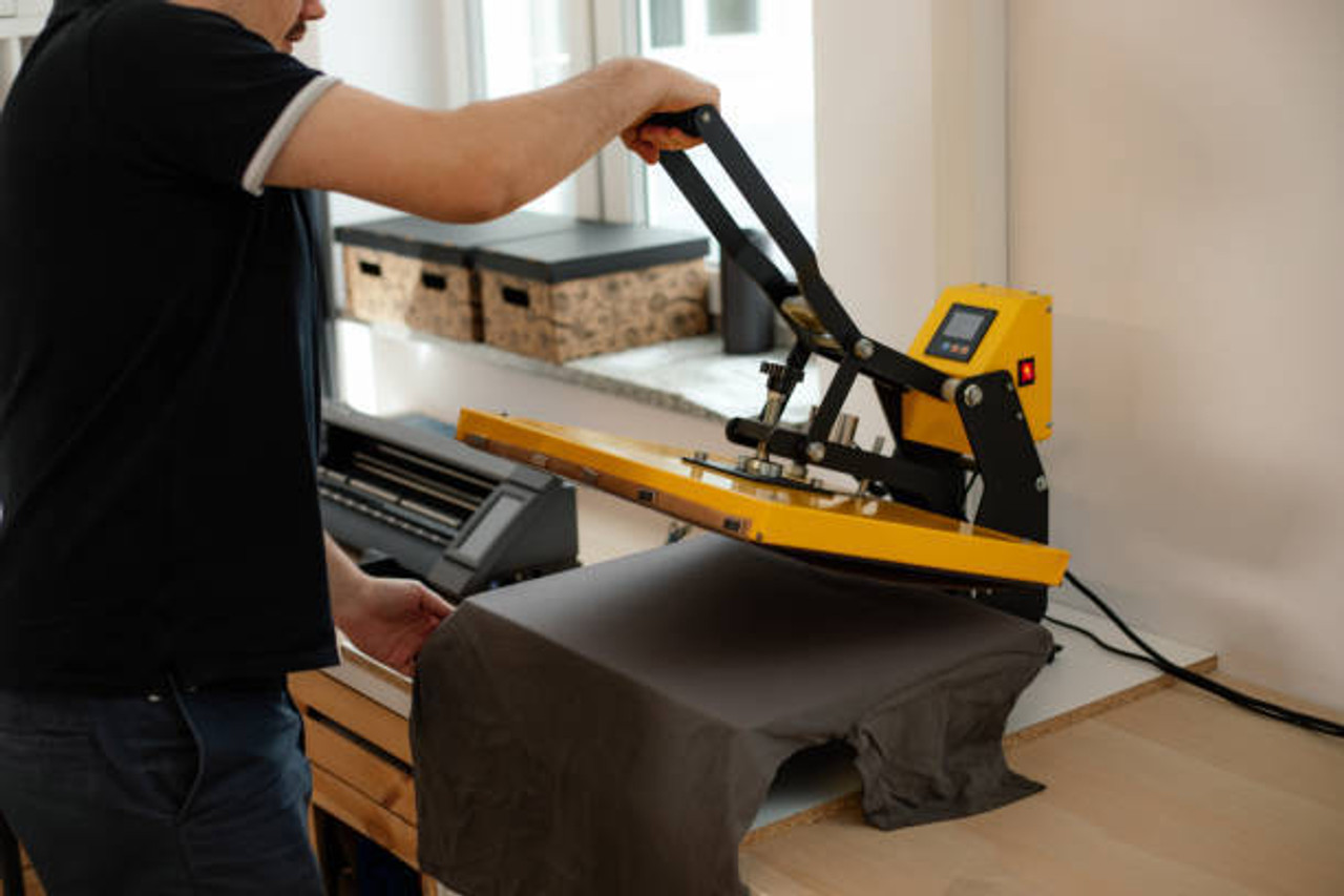 Applying a heat press transfer to a shirt at an event