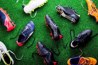 Cleats on turf, showing multiple options across various colors and sizes